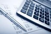 calculadora, bolígrafo y papel con números de presupuesto